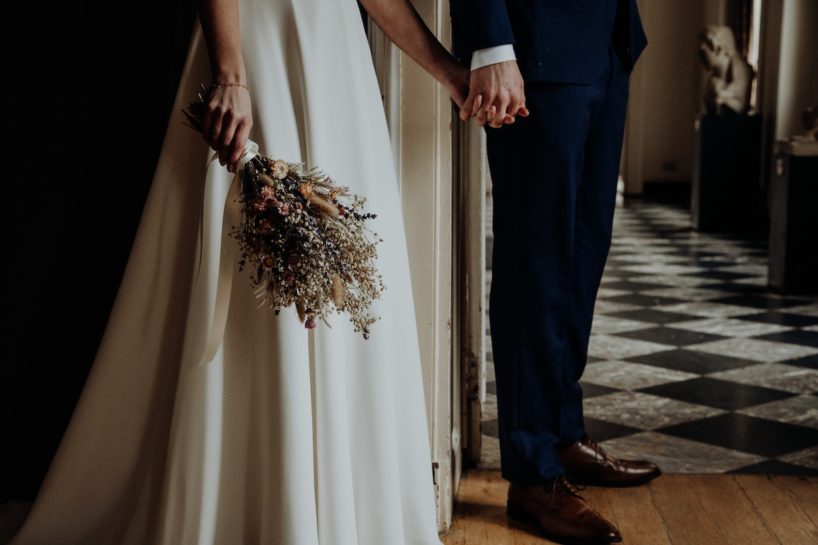 wedding couple holding hands with bouquet tile floor wedding photography philadelphia