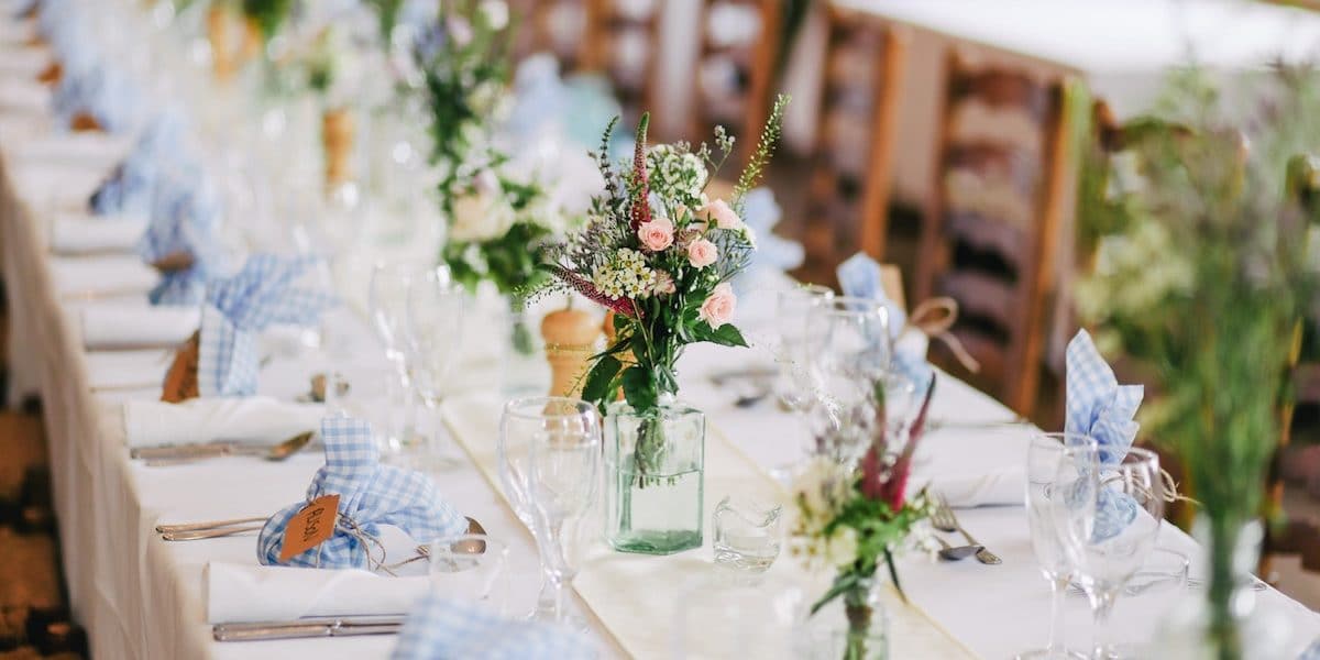 wedding-reception-table-setting-blue-napkins-flowers-wedding-videography-philadelphia