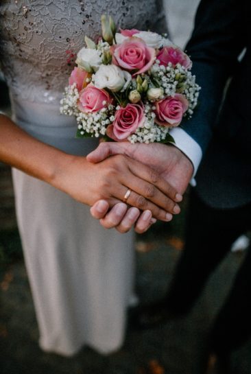 wedding couple bride groom pink flowers holding hands philadelphia e1637364474456